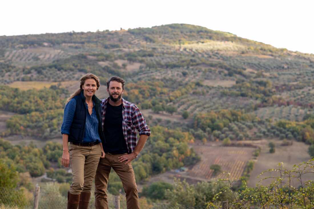 Siblings Marie-Charlotte Piro and Romain Piro stand among some of the olive trees they harvest in Tuscany, Italy, to create their olive oil.