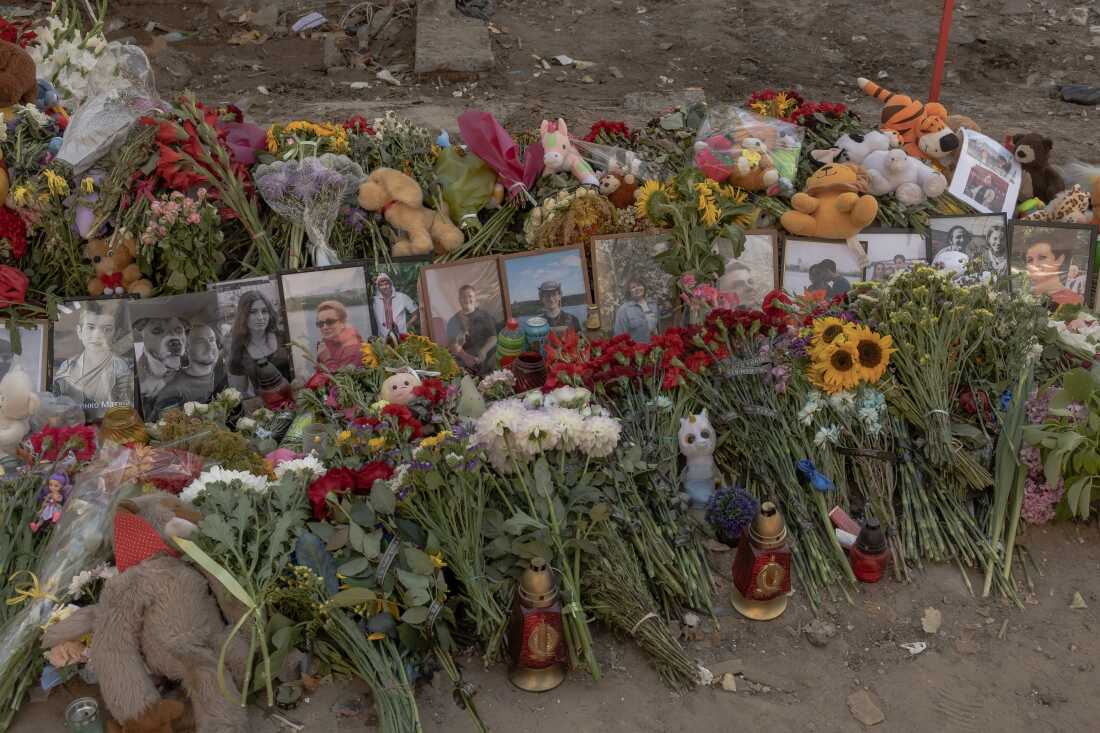 Ukrainians have made a makeshift memorial outside an apartment building in the capital Kyiv that was hit by a Russian airstrike on July 31. A combined missile and drone attack killed more than 30 civilians and wounded more than 150 in the city.