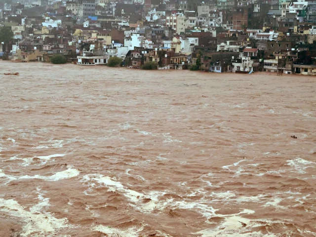 water flows down the overflowing tawi river following heavy rain in indian illegally occupied jammu and kashmir august 26 2025 photo reuters