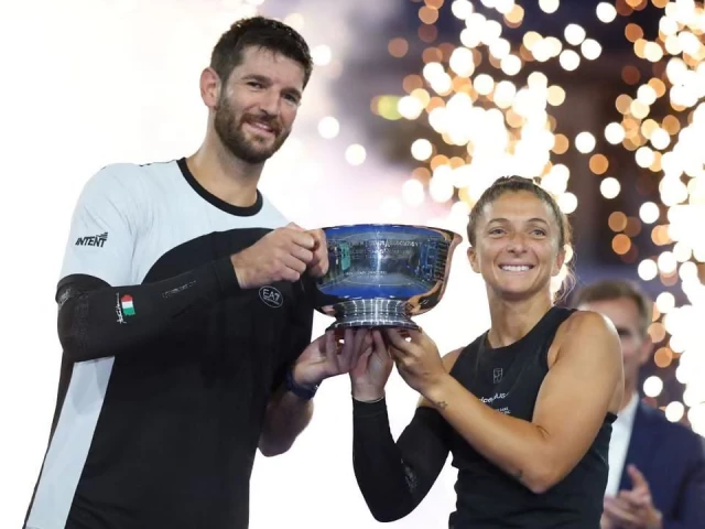 caption italy s andrea vavassori and sara errani celebrate with the trophy after winning their mixed doubles final at the us open photo afp