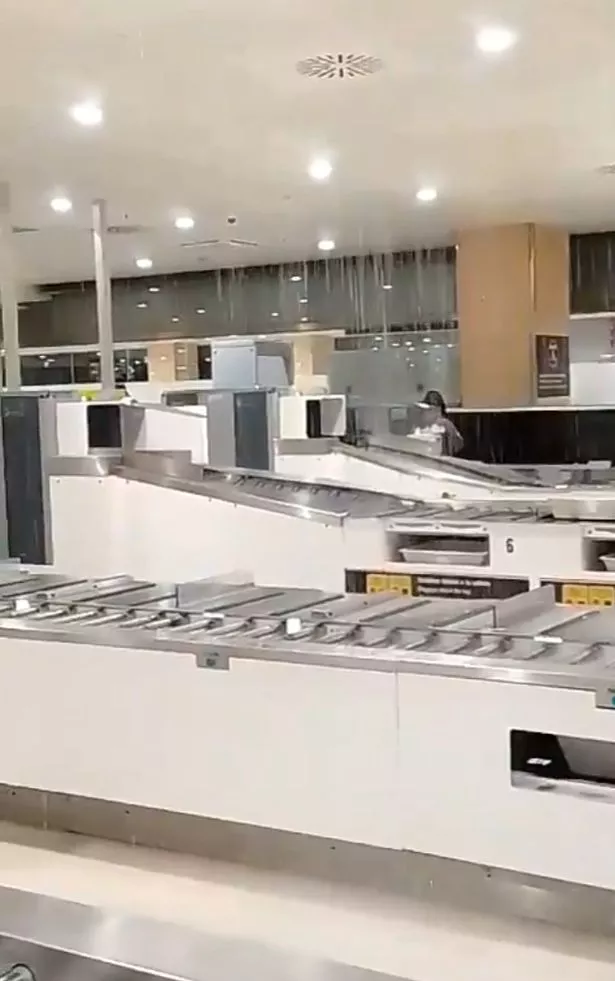 Rain is seen pouring into Ibiza airport