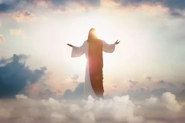 The resurrected Jesus Christ ascending to heaven above the bright light sky and clouds and God, Heaven and Second Coming concept