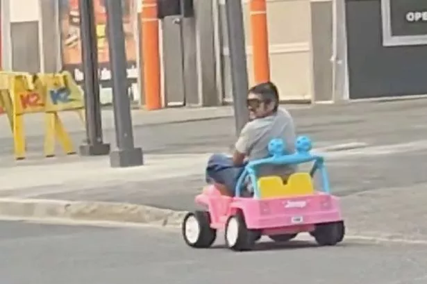man in barbie car