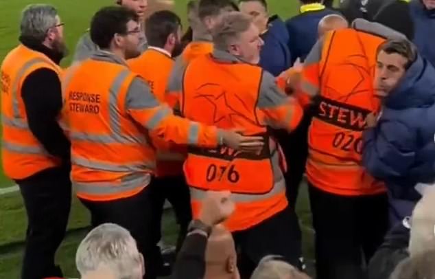 The Atletico Madrid member of staff (right) was caught on camera