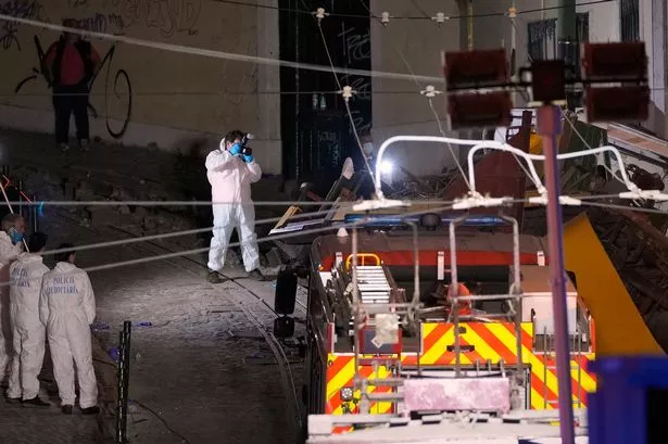 Police work at the site of the derailed tram in Lisbon
