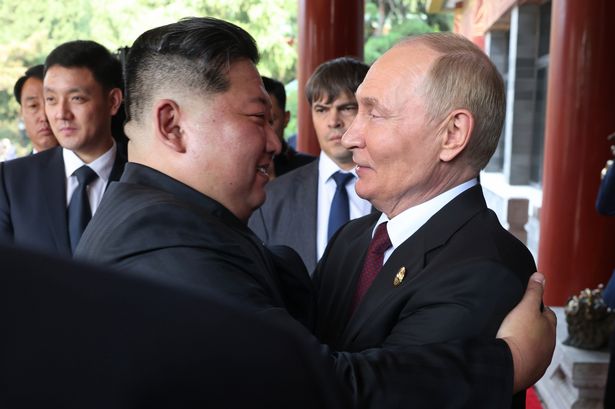 Russian President Vladimir Putin greets North Korean Supreme Leader Kim Jong Un