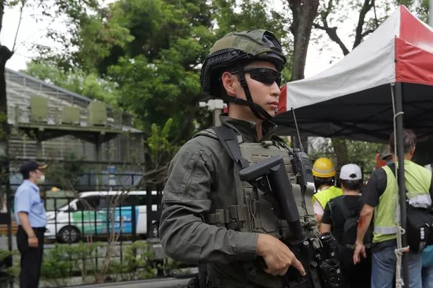 An armed soldier stands guard during an air raid drill in Taipei, Taiwan