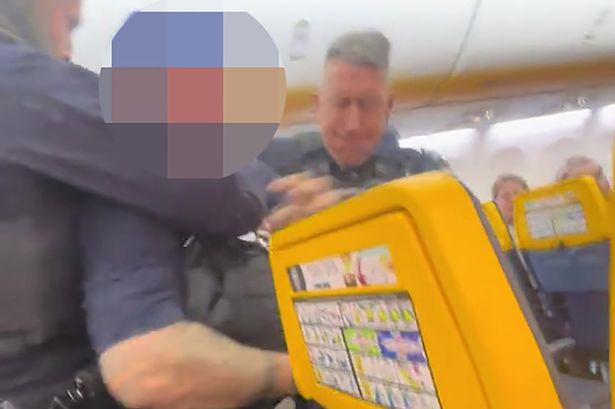 Men were marched off the plane by French police