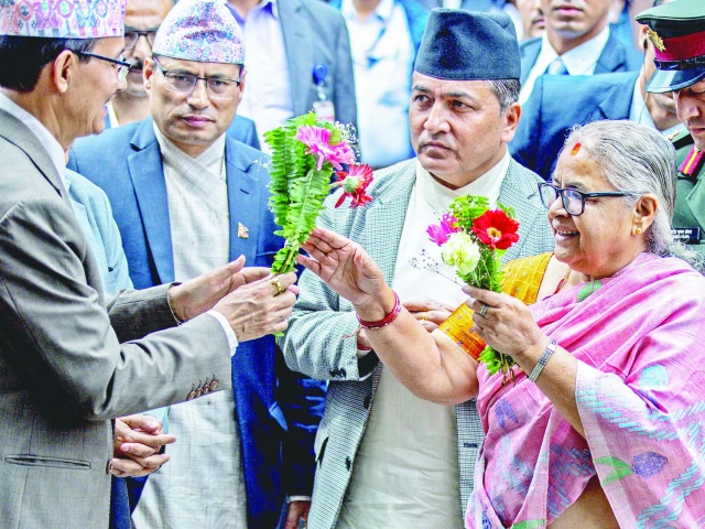 officials greet newly elected prime minister of nepal s interim government sushila karki as she arrives at the pm s office in kathmandu photo afp