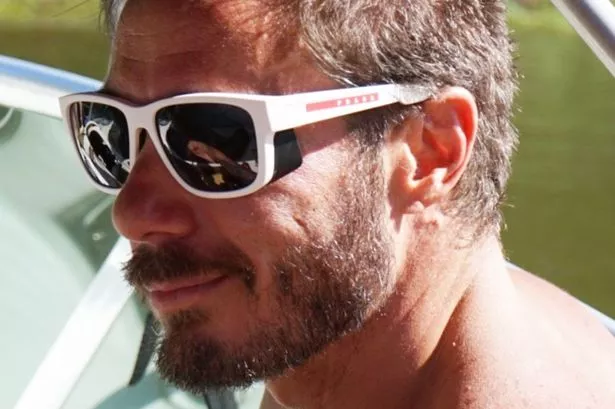 Marcelo wear sunglasses with water behind him