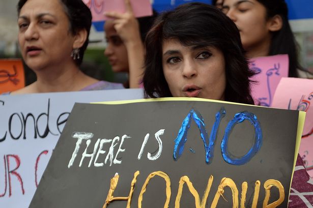 Pakistani human rights activists hold placards during a protest