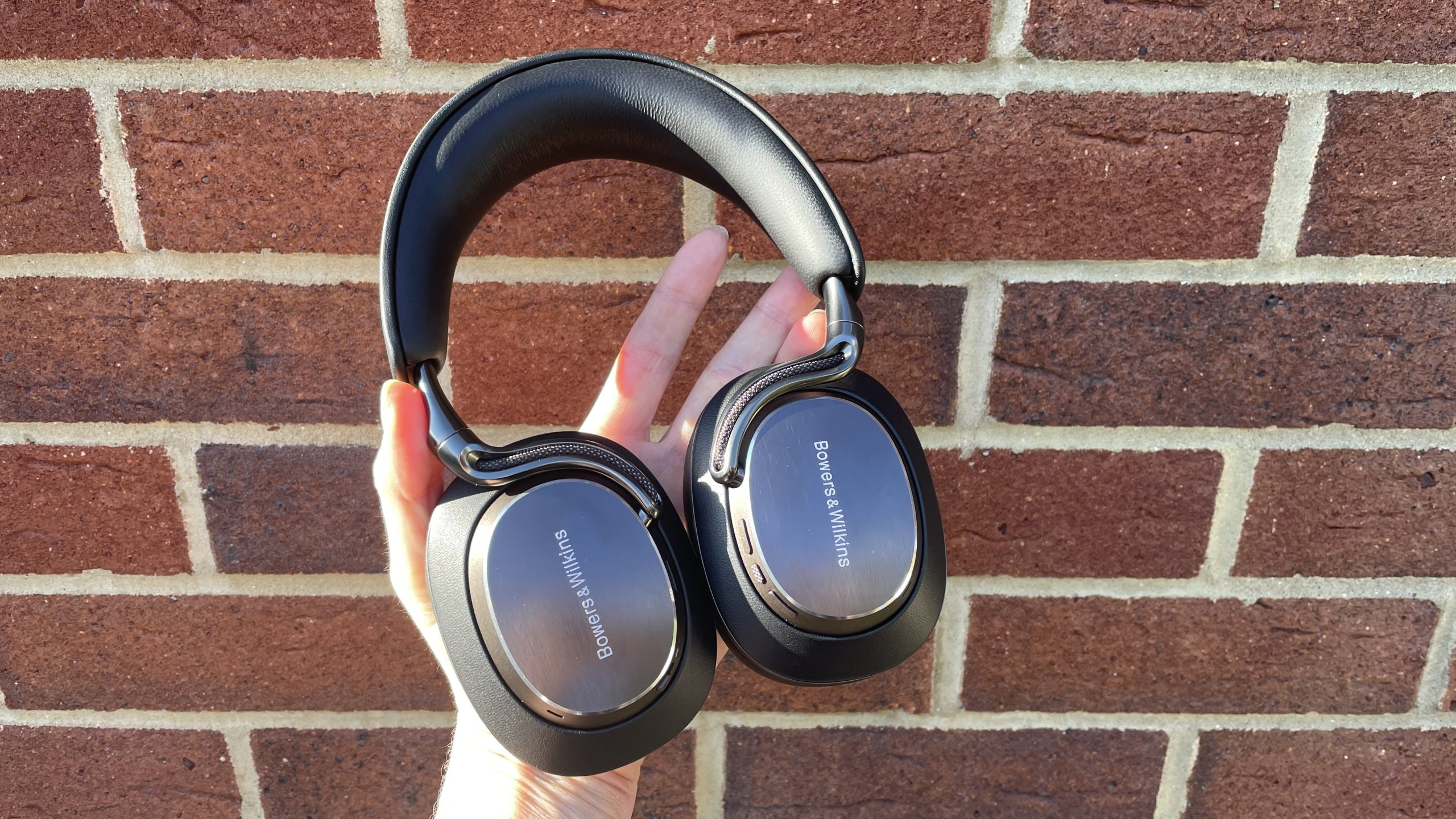 Bowers &amp;amp; Wilkins Px8 S2 in front of a red brick wall