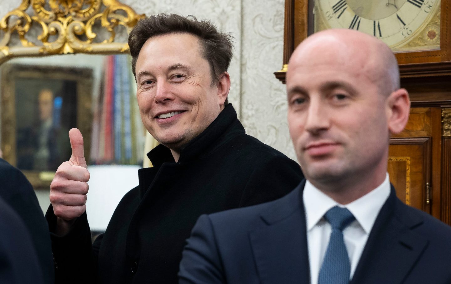 Elon Musk, chief executive officer of Tesla Inc., and Stephen Miller, deputy White House chief of staff for policy, during a meeting in the Oval Office of the White House in Washington, DC, US, on Thursday, Feb. 13, 2025.