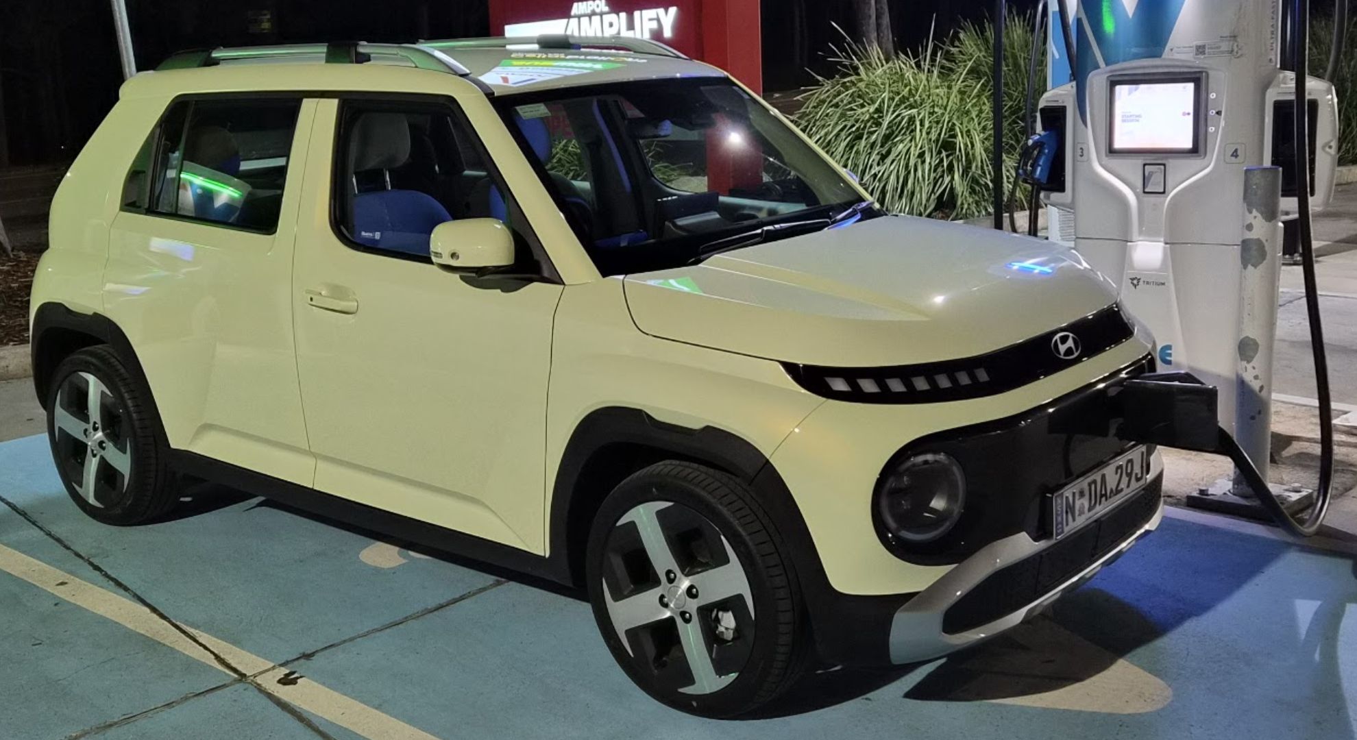 The Hyundai Inster recharging at an EV charging station