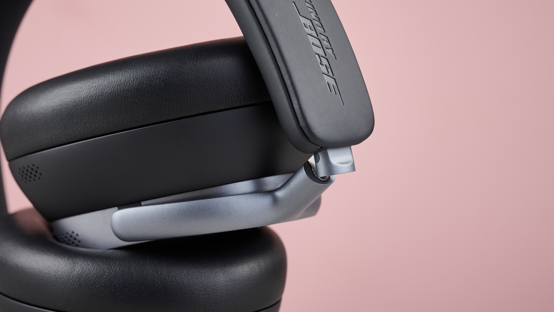 Baseus Inspire XH1 headphones against a pink background