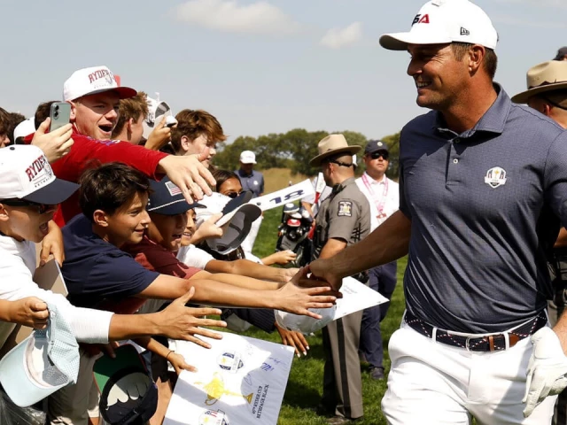 two time us open champion bryson dechambeau of the united states high fives fans during a practice round ahead of the 45th ryder cup at bethpage black where he has become a center of controversy photo afp