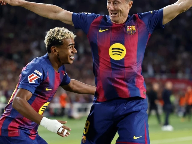 barcelona s polish forward robert lewandowski celebrates with lamine yamal after the winger set him up to score against real sociedad photo afp