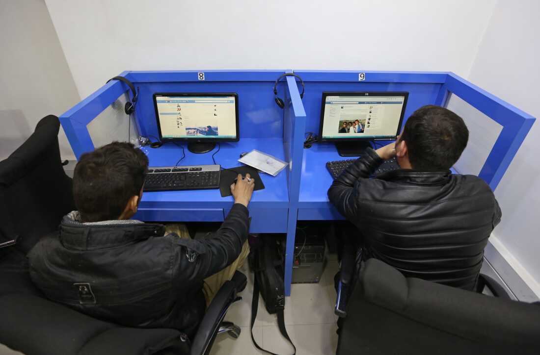 FILE - In this Feb. 10, 2016 photo, Afghanis access social media websites at a private internet cafe in Kabul, Afghanistan. (AP Photo/Rahmat Gul, file)