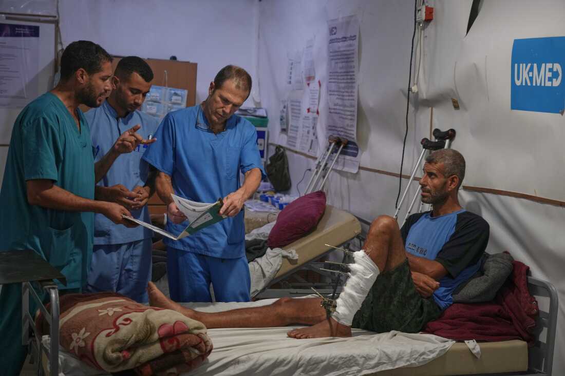 Dr. Paul Ransom of the British humanitarian medical NGO UK-Med, assisted by local medical staff, treats patients at a field hospital in Muwasi, near Khan Younis in the southern Gaza Strip, Saturday, Sept. 27, 2025.