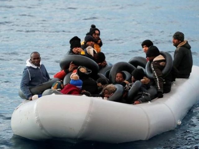 migrants are seen on a dinghy following a failed attempt to cross to the greek island of lesbos as a turkish coast guard boat aproaches them on the waters of the north aegean sea off the shores of canakkale turkey march 6 2020 photo reuters