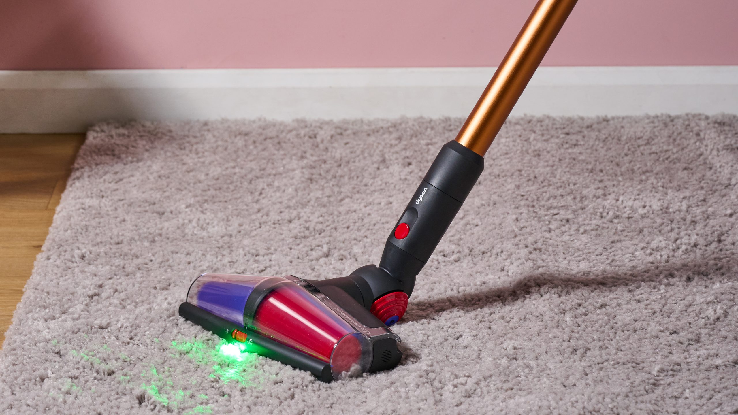 Close up of floorhead on Dyson V16 Piston Animal cordless stick vacuum being used on a rug