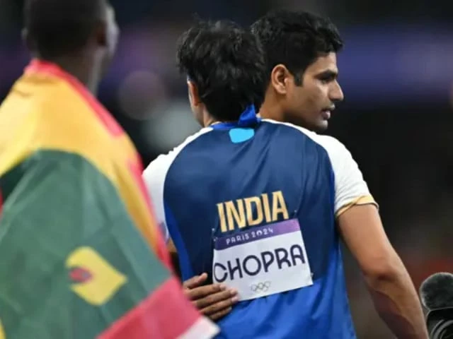 silver medallist india s neeraj chopra c front congratulates gold medallist pakistan s arshad nadeem after competing in the men s javelin throw final of the athletics event at the paris 2024 olympic games at stade de france in saint denis north of paris on 8 august 2024 photo afp