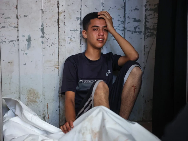 a palestinian youth mourn by the body of a relative killed in israeli strikes on gaza city at dawn at the al shifa hospital on september 2 2025 photo afp