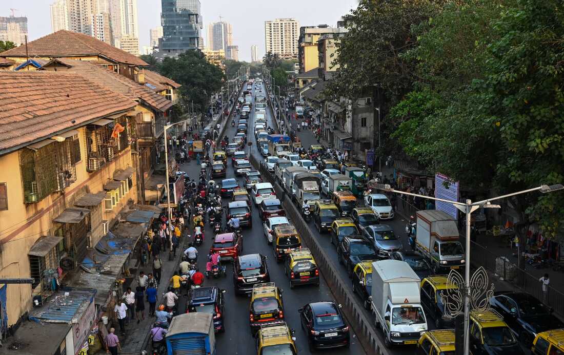 Lanes of traffic are packed with vehicles on a bridge in India.