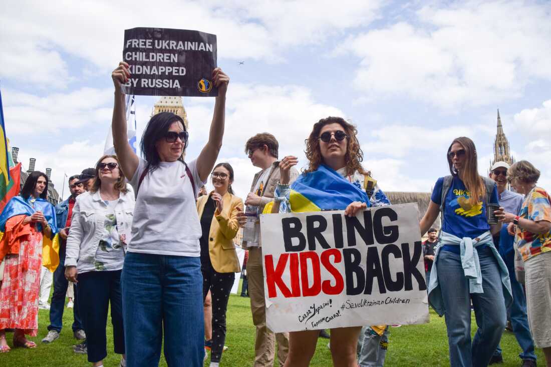 Protesters hold placards during a demonstration in Parliament Square in London, demanding the release of Ukrainian children kidnapped by Russia and an end to Russian aggression in Ukraine. The Ukrainian government has insisted that the return of children from Russia be part of any peace deal with the country.