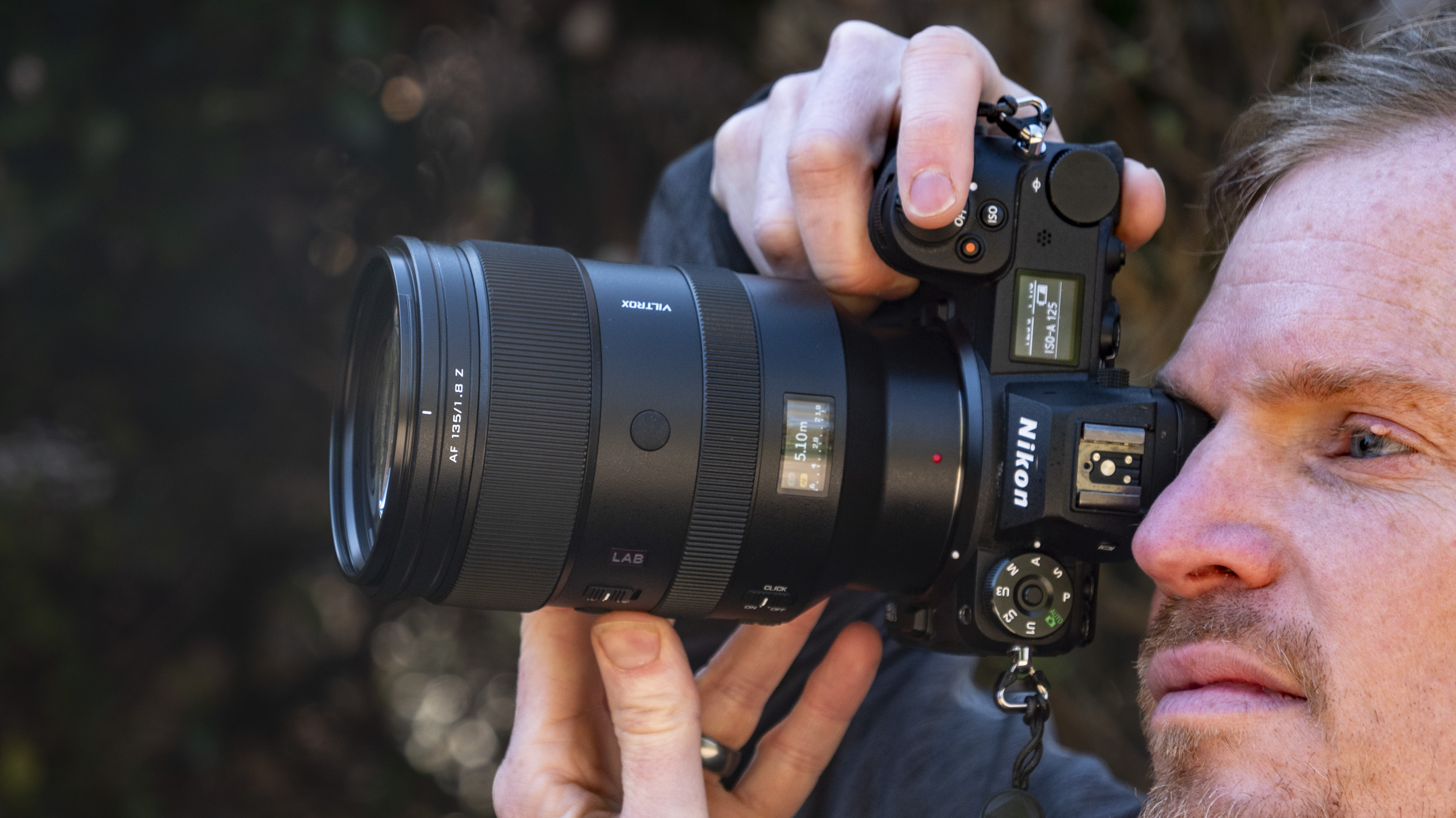 Viltrox 135mm F1.8 Lab lens for Nikon Z-mount, in the hand, attached to a Nikon Z6 II