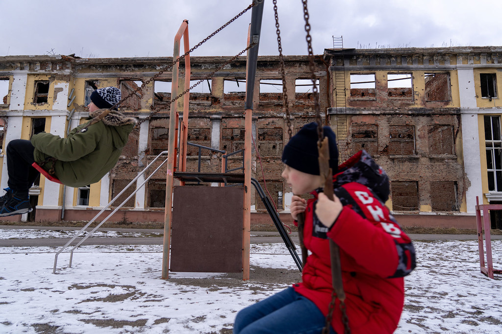Boys play amidst the ruins of a school in Kharkiv, Ukraine.