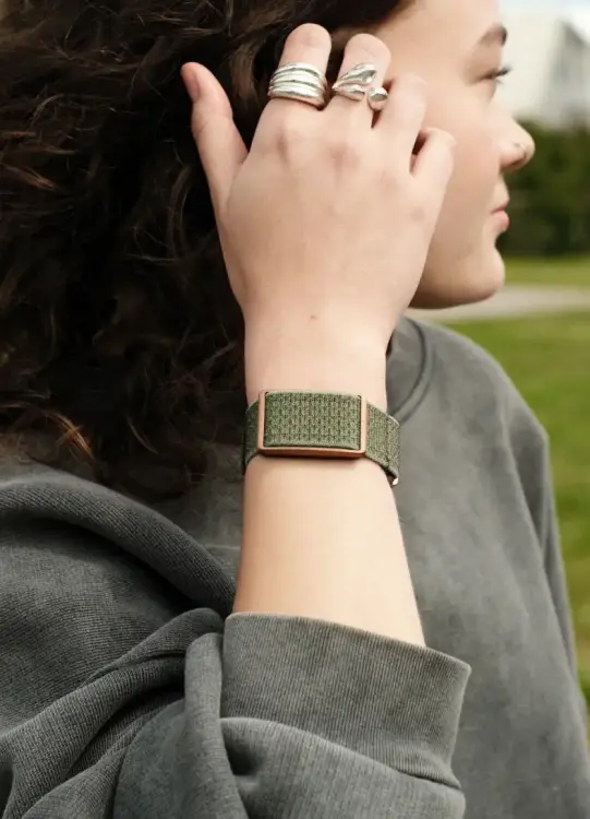 polar loop fitness tracker on woman