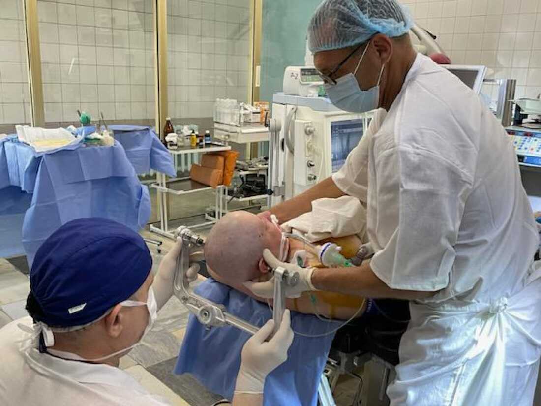 Dr. Andriy Sirko (left), the head of of neurosurgery at Mechnikov Hospital in Dnipro, Ukraine, treats a patient along with Dr. Rocco Armonda, a visiting U.S. neurosurgeon. The hospital is just 60 miles from the frontline of the Russia-Ukraine war and handles the most serious brain injuries.