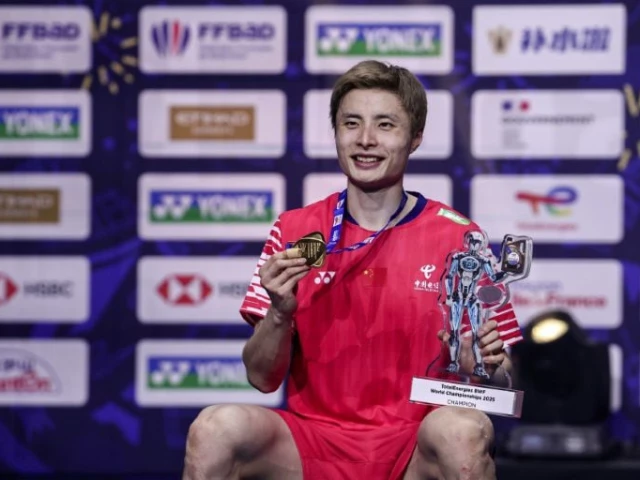 chinese world champion shi yuqi celebrates with his trophy in paris photo afp