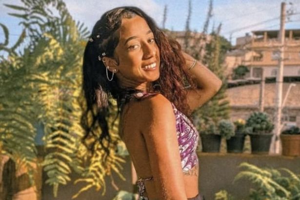 Júlia de Paula Barbosa smiles in an outdoor area