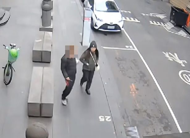 CCTV footage shows a woman approach as Wan Lai walks down the street