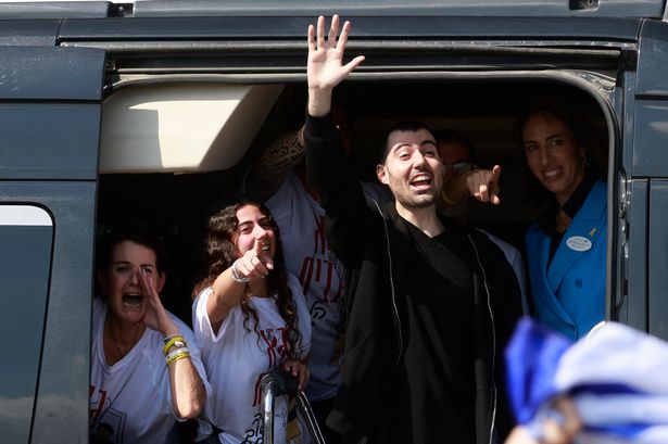 Released Israeli hostage Guy Gilboa Dalal waves to well wishers
