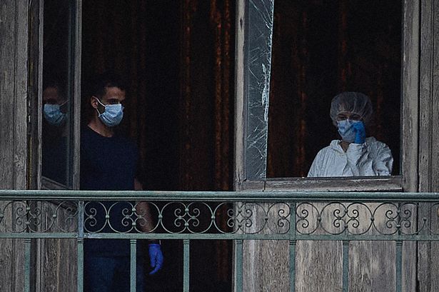 A French Forensics Officer examines the cut window and balcony of a gallery at the Louvre Museum which was the scene of a robbery at the world famous museum earlier in the day on October 19, 2025 in Paris, France
