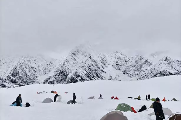 Hikers amid deep snow at Tangxiang camp in the Karma Valley on October 5 following a sudden heavy snowfall in the region