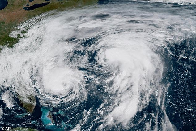 There are two hurricanes in the Atlantic, Imelda (left) and Humberto (right), which are performing a rare