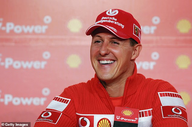 Michael Schumacher signing a helmet earlier this year was a