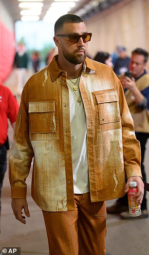 Travis Kelce opted for a striking orange set as he entered Arrowhead on Monday night