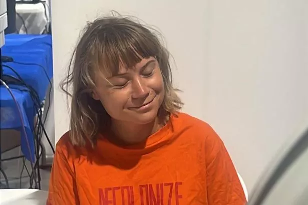 Greta Thunberg pictured wearing an orange shirt after being detained by Israel