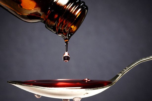 Pouring medication or antipyretic syrup into spoon