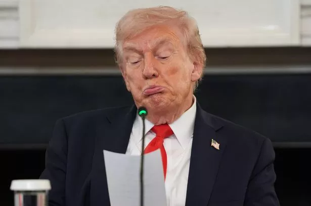 Trump reading the message he was given by Marco Rubio