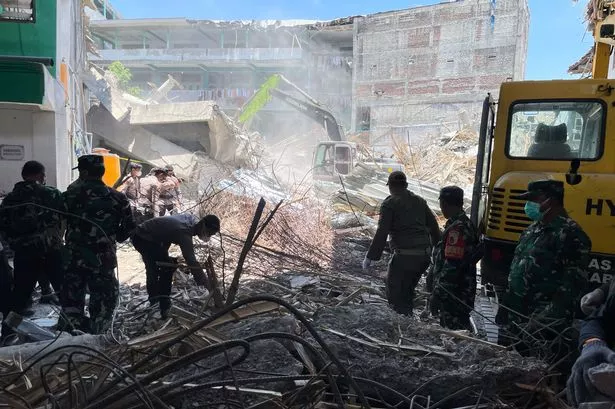 Rescuers clear rubble as they search for victims