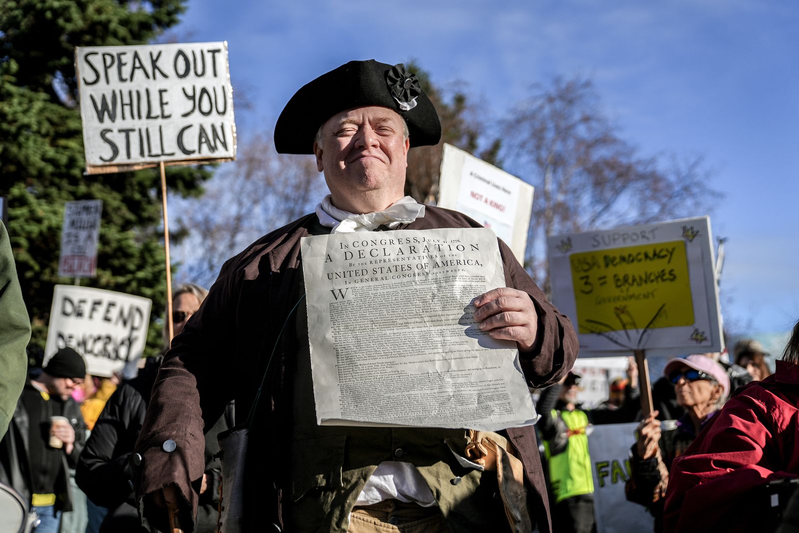 A protestor dressed as Ben Franklin