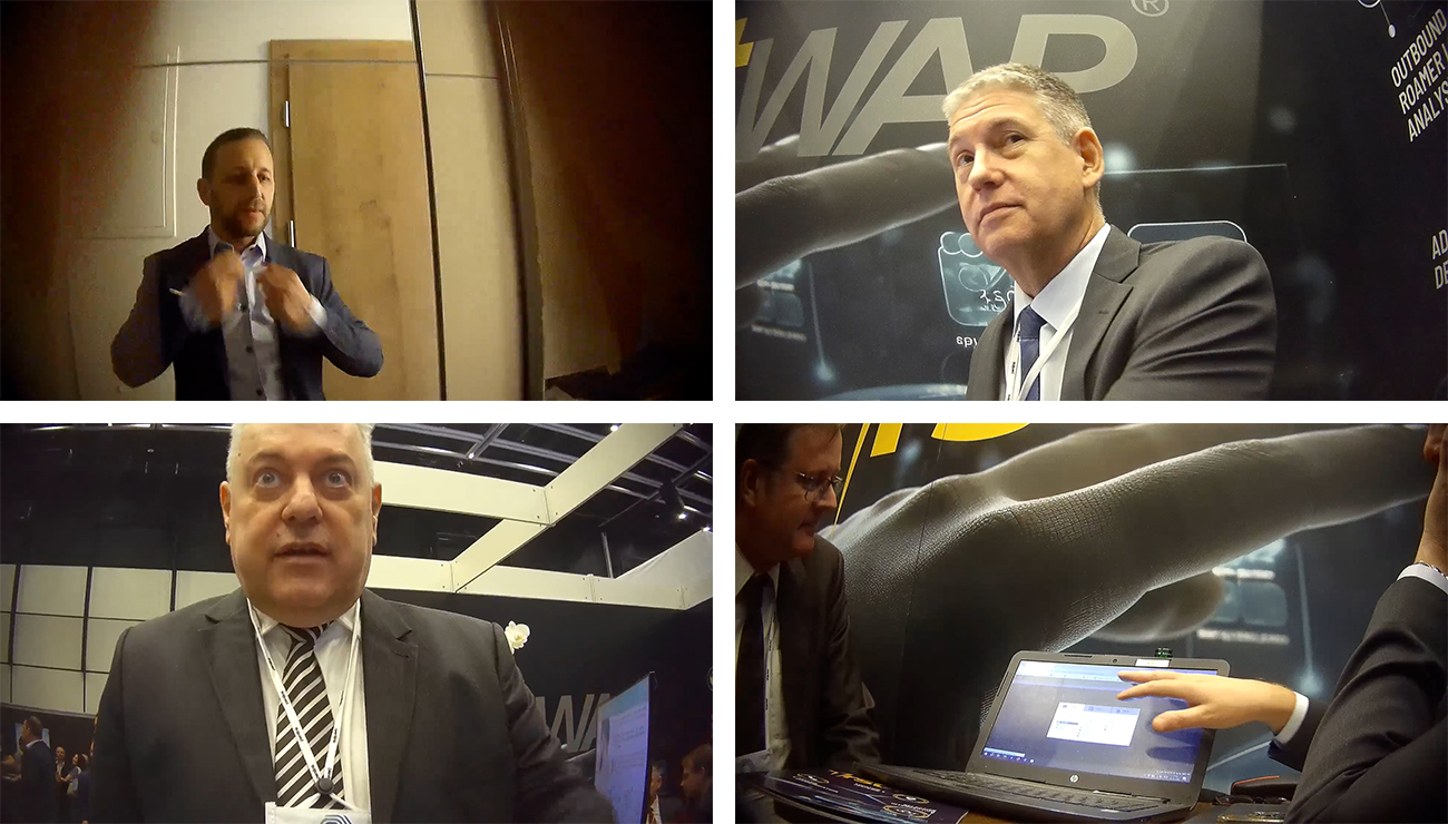 A four-panel grid of video footage showing men in suits at what appears to be a business conference or trade show. Top left: A man adjusting his tie in front of a wooden door. Top right: A middle-aged man in a dark suit and tie looking off-camera, with a blurry background featuring the letters