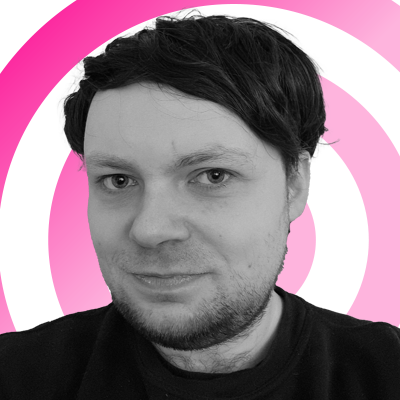 Rhys Wood headshot on a pink