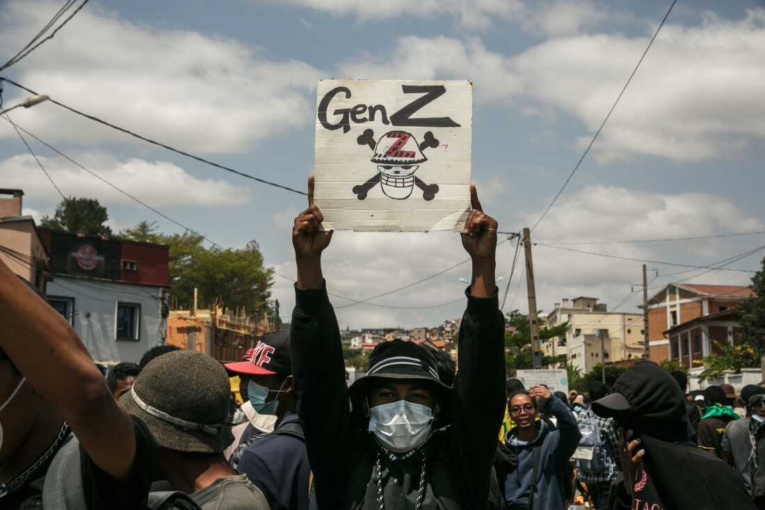 A protester holds a placard during a demonstration against repeated water and electricity outages in Madagascar.